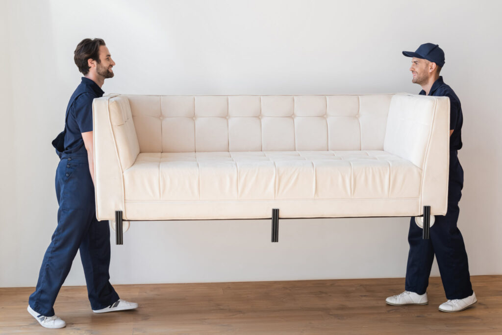Port Elizabeth Relocations - side view of movers carrying white couch in living Port Elizabeth Household Removals